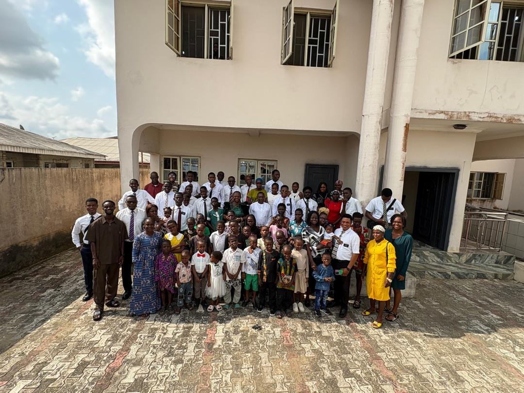 A group of church members, children, and missionaries gathered together
