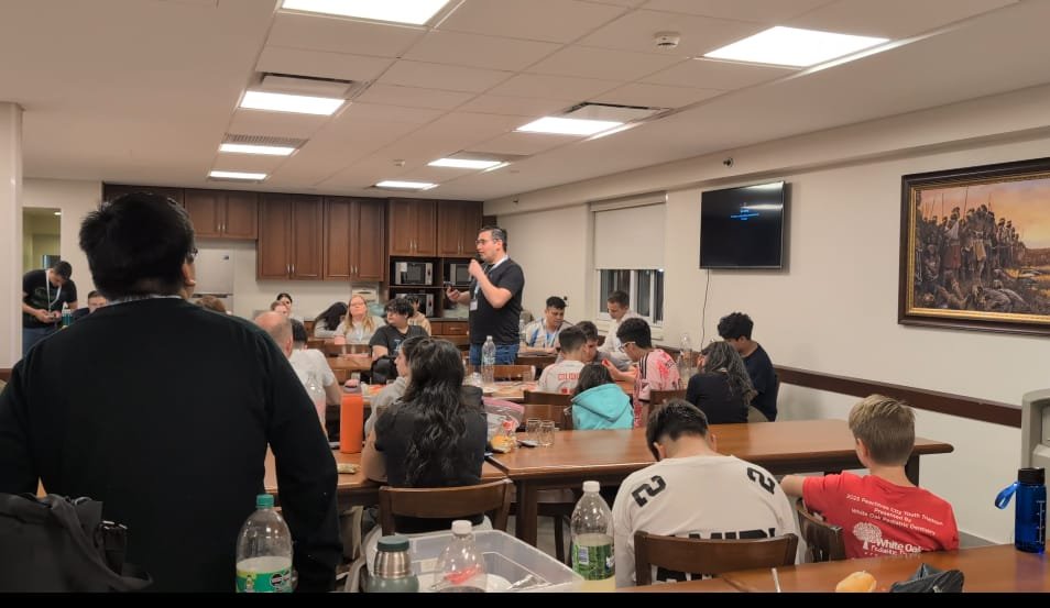 Families and leaders gathered for a spiritual home evening at the hostel